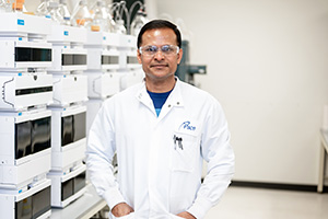 Pace® Life Sciences Scientist in front of Laboratory Equipment
