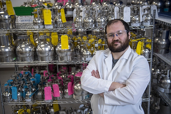 Pace Scientist Posing near Air Canisters at Pace Air Laboratory, Air Quality Testing