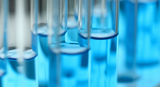row of test tubes with blue liquid. Biological Tissue Analysis (BIOTA), Pace Biota laboratories
