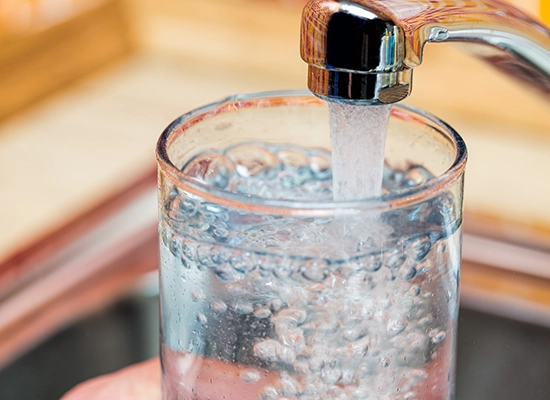 closeup of household sink faucet filling water glass. Lead and Copper in Water, Copper in Water, Lead and Copper Rule, Copper in Drinking Water