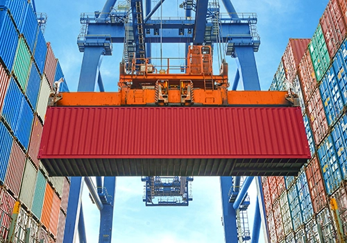 Crane loading shipping container at ship yard. Dissolved Gases, Dissolved Gases Testing, Dissolved Gases Analysis, What are dissolved gases? Dissolved gases in water