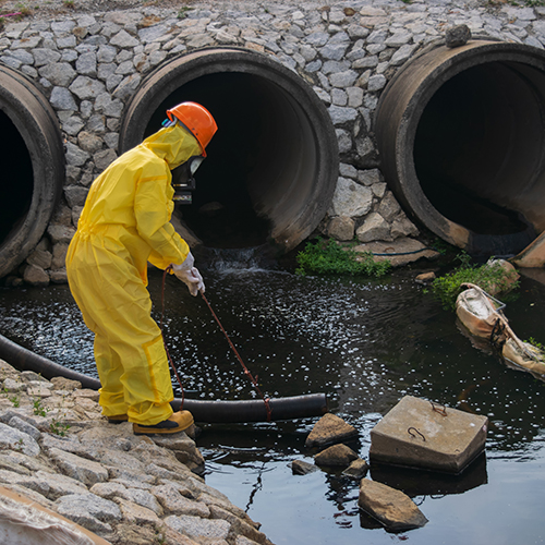 person in hazmat suit taking sample of water near bridge. When the term trace metal is used, people are often referring to metals, such as copper, zinc, and iron, that are essential in small amounts for health in living organisms. There is some overlap between heavy metals and trace metals. For instance, copper is a heavy metal but also a trace metal essential to bone and heart health. Despite their necessity for organic life, some trace metals can also become toxic or even carcinogenic if present in larger amounts.