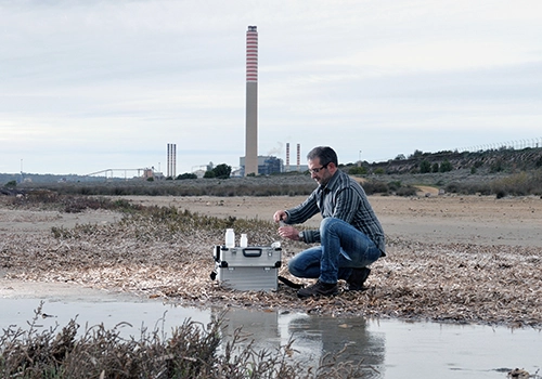 Environmental consultant taking sample at factory site. Pace services for environmental consulting.