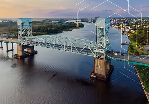 PFAS Rules and Regulations Spotlight: North Carolina. Aerial view of Cape Fear Memorial Bridge crossing the Cape Fear river in Wilmington, NC.